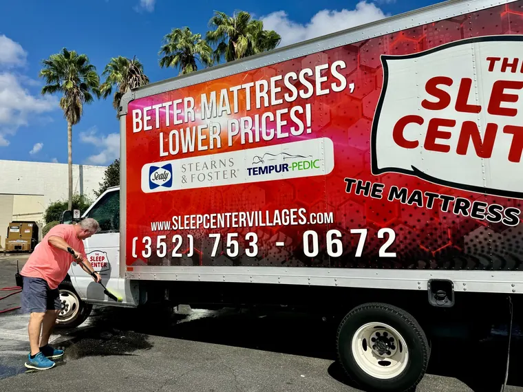 A Sleep Center branded delivery truck getting washed before a delivery run